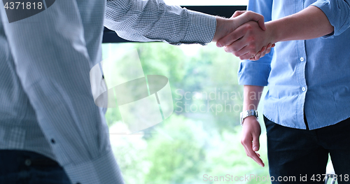 Image of cloasing the deal in modern office interior