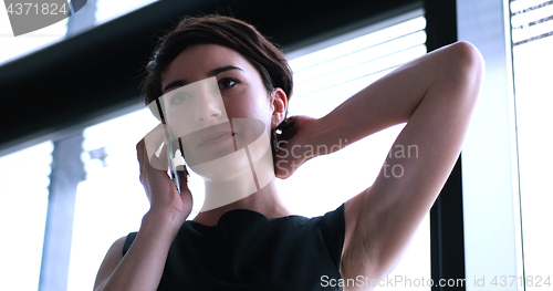 Image of Business Girl Standing In A Modern Building Near The Window With