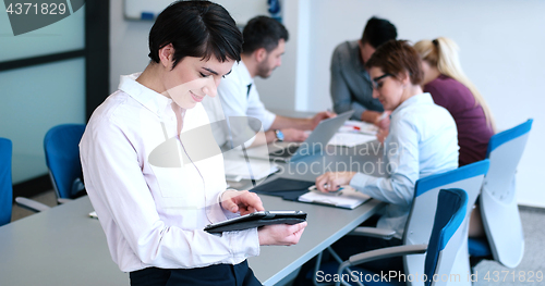 Image of Portrait of  smiling casual businesswoman using tablet  with cow