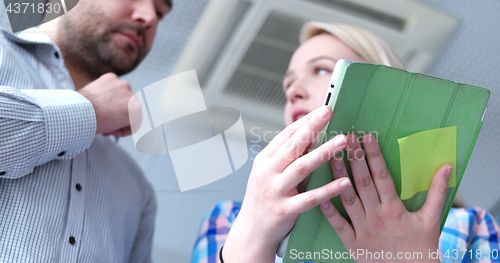 Image of low angle shot of business people using technology