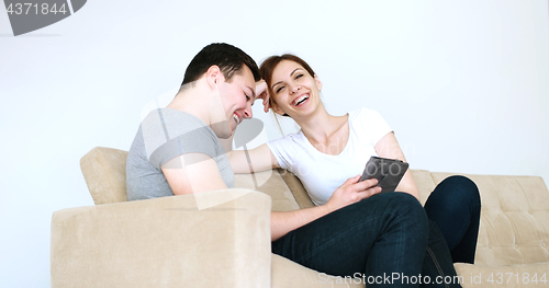 Image of Young Couple using digital tablet at home