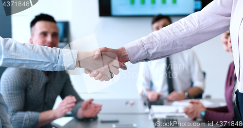 Image of cloasing the deal in modern office interior