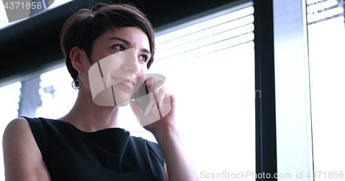 Image of Business Girl Standing In A Modern Building Near The Window With