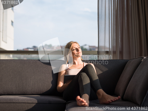 Image of Woman Using Tablet On Couch At Home