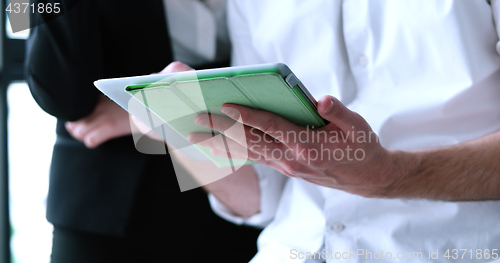 Image of low angle shot of business people using technology