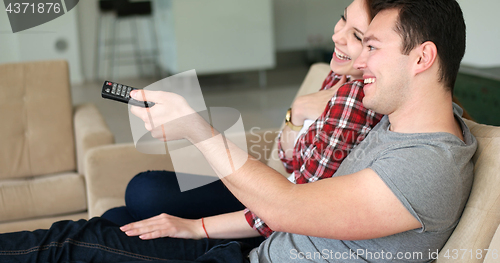 Image of Young Couple Watching Tv at villa