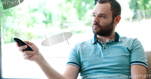 Image of Happy Man Watching Television