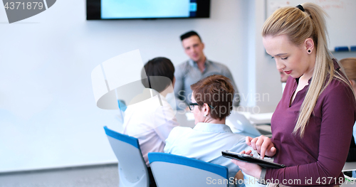 Image of Pretty Businesswoman Using Tablet In Office Building during conf
