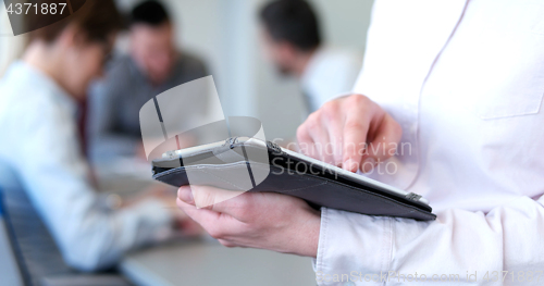 Image of Businessman using tablet in modern office