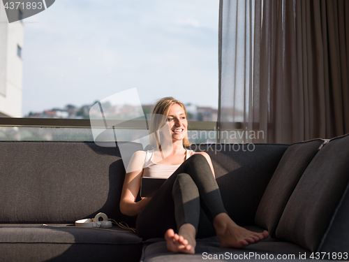 Image of Woman Using Tablet On Couch At Home