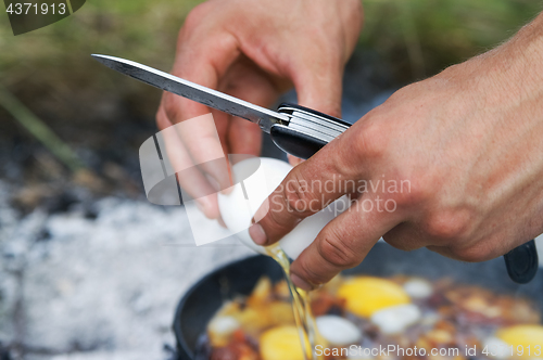 Image of Fried eggs cooking on camp fire