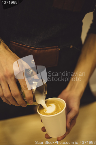 Image of Bartender pouring coffee to cup