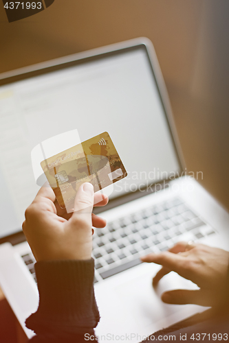 Image of Woman using credit card for online purchase