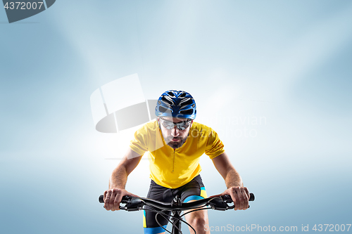 Image of The bicyclist on gray, studio shot.