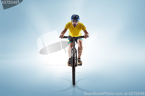 Image of The bicyclist on gray, studio shot.