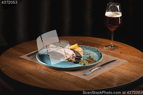 Image of grilled pork ribs on dark plate
