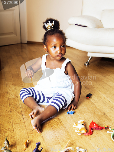 Image of little cute african american girl playing with animal toys at ho