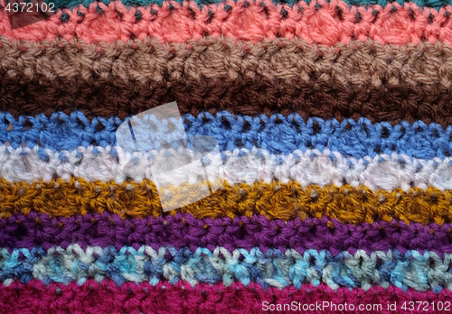 Image of Background of crocheted stitches in multi-coloured stripes