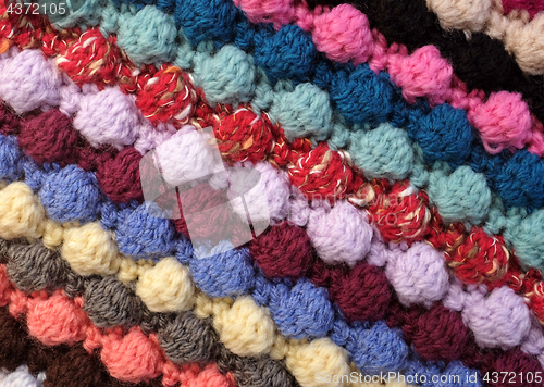 Image of Diagonal stripes of multi-coloured bobble crochet stitches backg