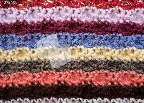 Image of Horizontal stripes of coloured crochet stitches background