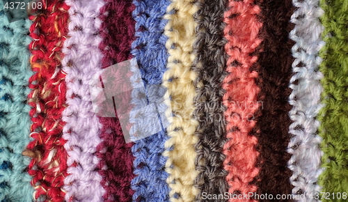 Image of Crocheted yarn stitches in mixed colour stripes background