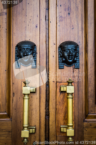 Image of Sphinx heads entrance on wooden door