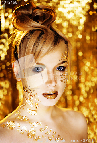 Image of beauty blond woman with gold creative make up