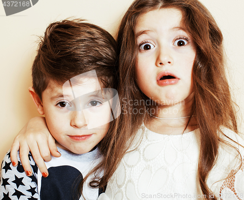 Image of little cute boy and girl hugging playing on white background, happy family smiling brother and sister fooling around, lifestyle people concept