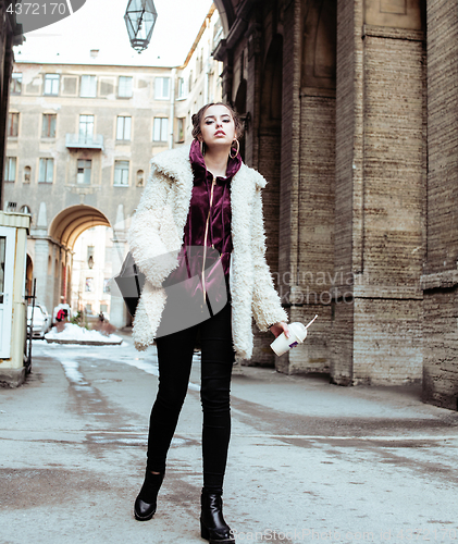 Image of young pretty stylish teenage girl outside on city street fancy f