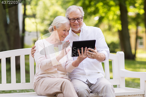 Image of senior couple with video chat on tablet pc at park