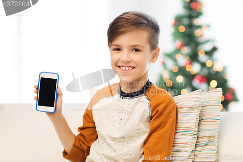 Image of boy with smartphone at home at christmas