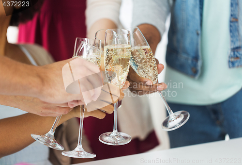 Image of friends clinking glasses of champagne at party