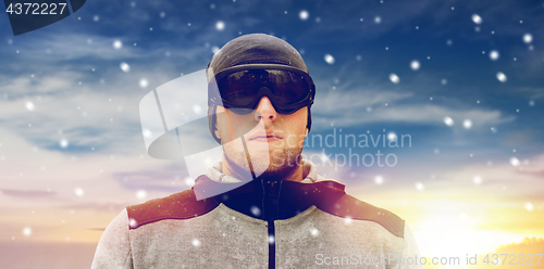 Image of sports man with ski goggles in winter outdoors