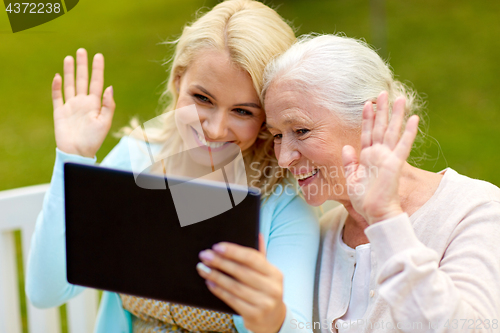 Image of daughter with tablet pc and senior mother at park