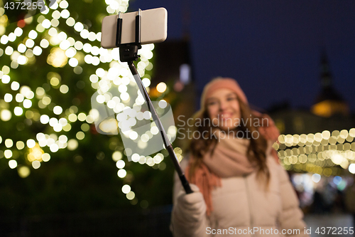 Image of young woman taking selfie at christmas town
