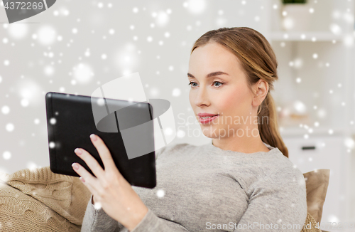 Image of smiling woman with tablet pc at home