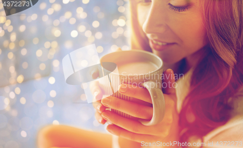 Image of close up of happy woman with cocoa cup at home