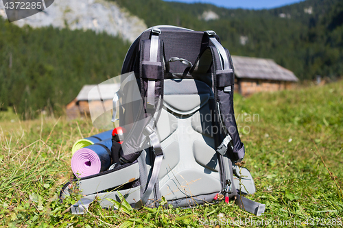 Image of Backpack and yoga mats on mountain meadow.