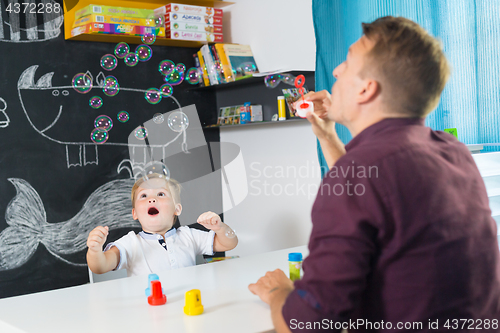 Image of Cute little toddler boy at speechtherapist session.