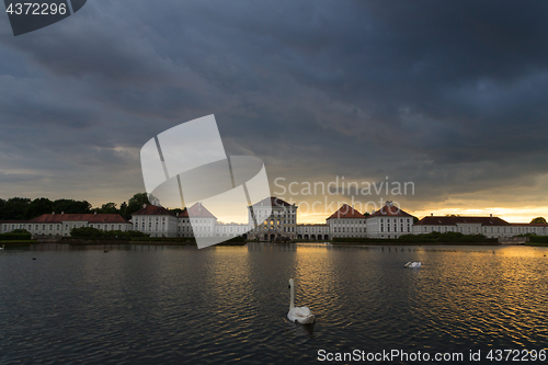 Image of Dramatic scenery of post storm sunset of Nymphenburg palace in Munich Germany.