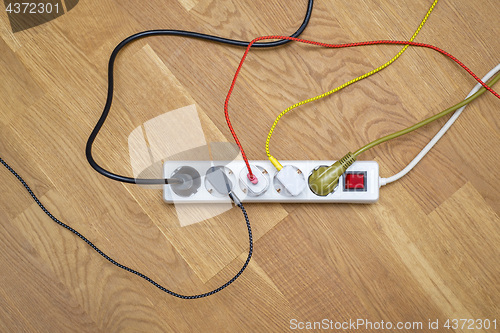 Image of colorful plugs attached into extension cord