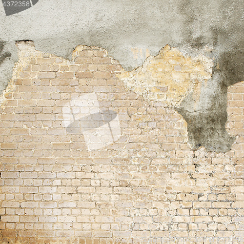 Image of abandoned grunge cracked brick stucco wall