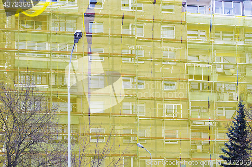 Image of restoration of old house under yellow net