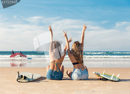 Image of Two surfer girls at the beach