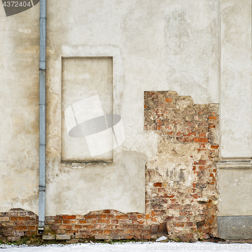 Image of abandoned grunge house, cracked brick stucco wall