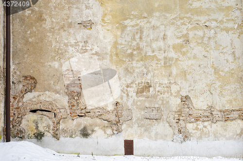 Image of abandoned grunge house, cracked brick stucco wall