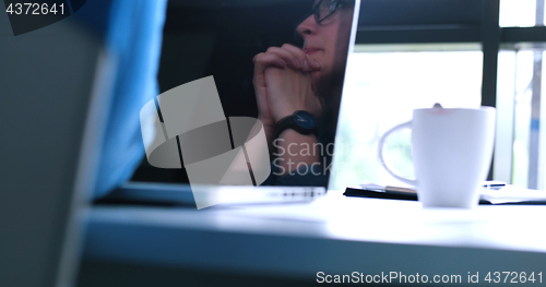 Image of group of business people having a meeting in bright office