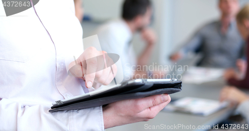 Image of woman using tablet in bright office