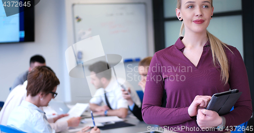 Image of Pretty Businesswoman Using Tablet In Office Building during conf