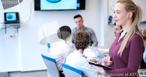 Image of Pretty Businesswoman Using Tablet In Office Building during conf